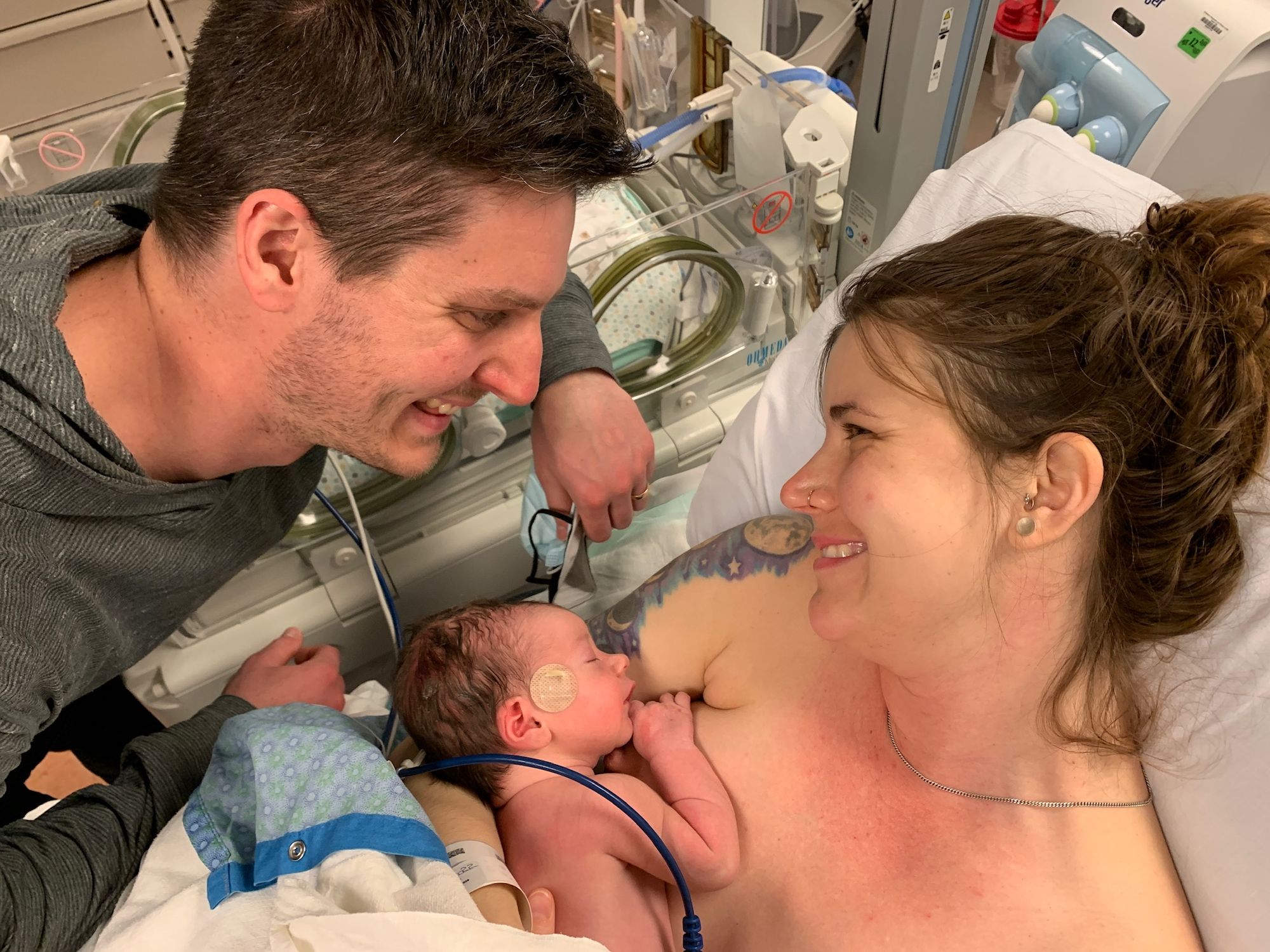 Husband and wife right after birth of son. Positive birth story. 