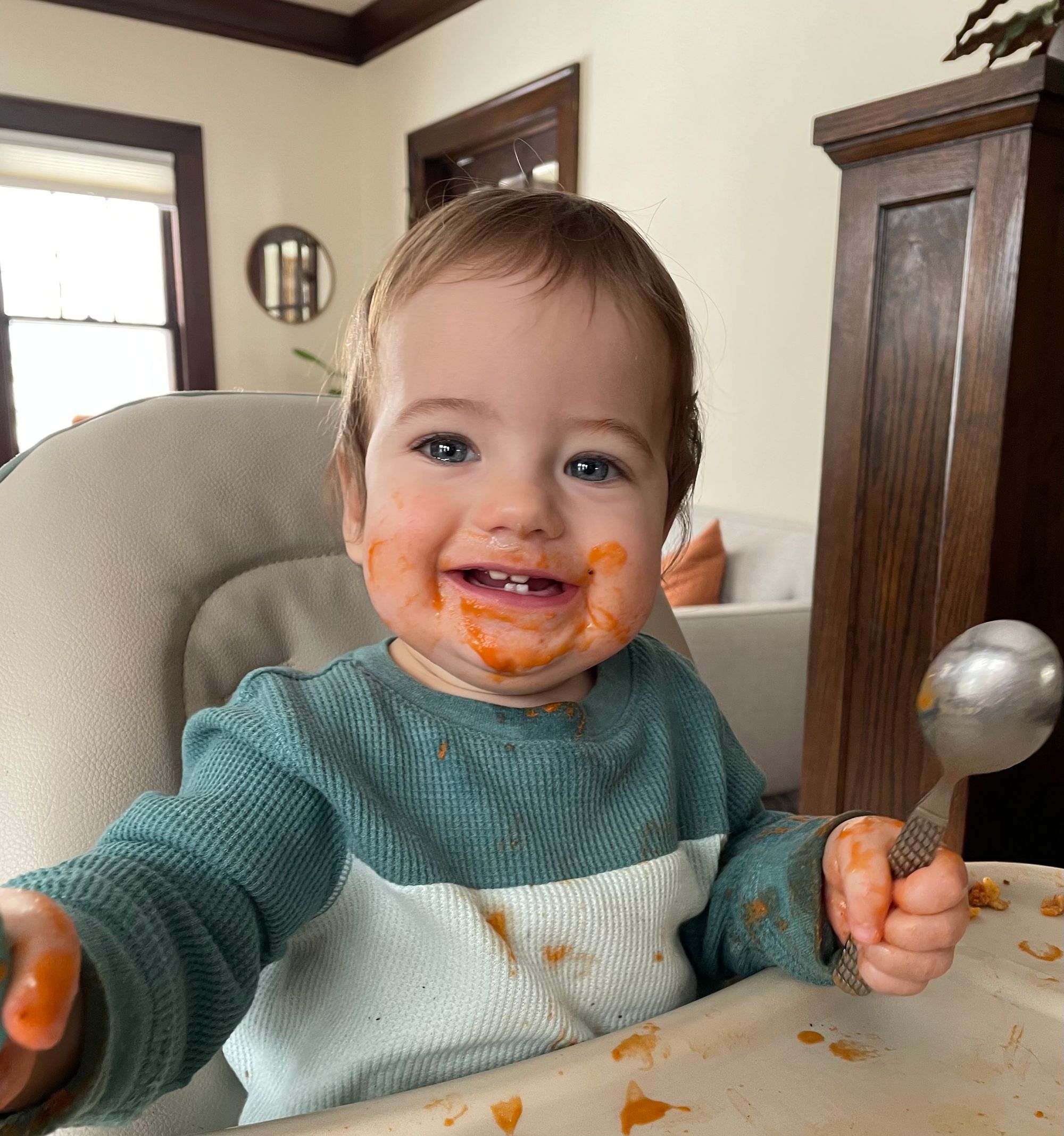 Infant eating with metal utensils