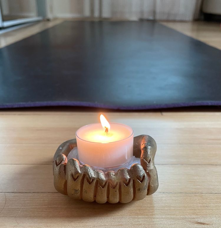 Cultivating a home yoga practice. Candle in front of yoga mat 